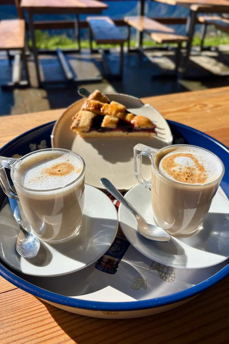 Two cappuccinos and a slice of pie.