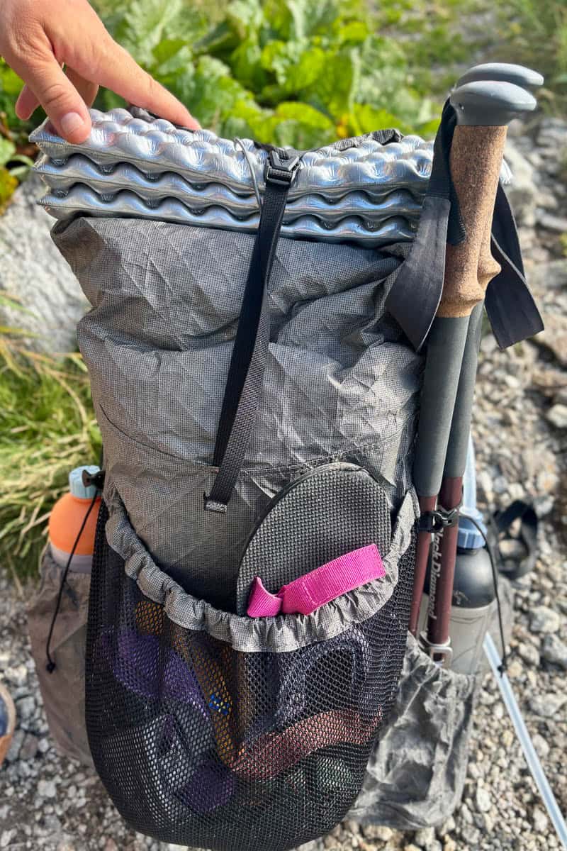 Backpack loaded with trekking poles and gear for the Tour du Mont Blanc.