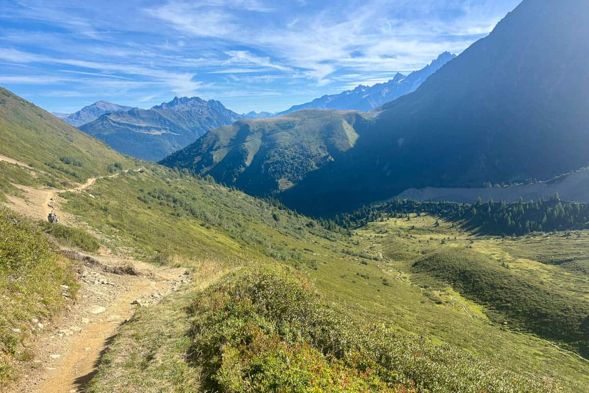Dirt trail on grassy mountainside in Stage 1 of the Tour du Mont Blanc.