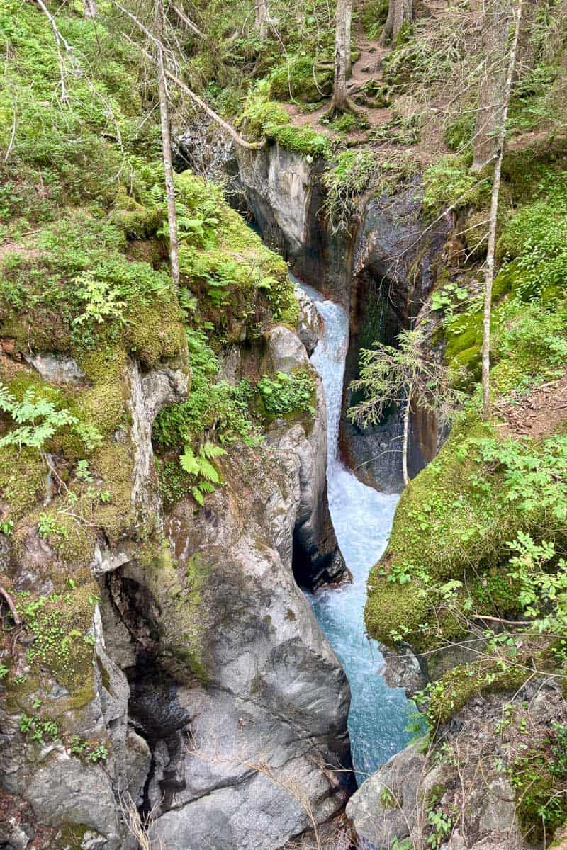 Waterfall flowing through narrow gorge on Tour du Mont Blanc Stage 1.