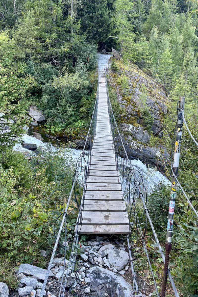 Swinging bridge across waterfall.