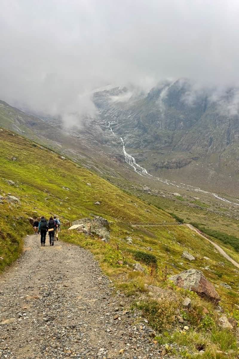 Distant waterfall visible from trail.