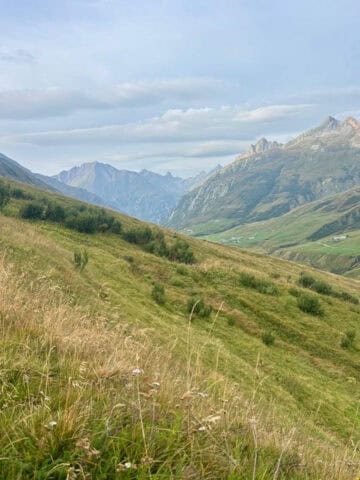 View of alpine mountains and grassy hillsides on Stages 3 and 4 of the Tour du Mont Blanc.