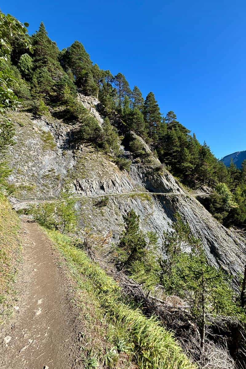 Cliff walk section of Stage 7 of the Tour du Mont Blanc with sheer drop down one side.