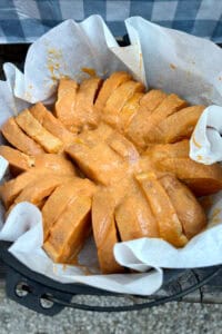 Slices of bread soaked in pumpkin custard and placed in cast-iron dutch oven.
