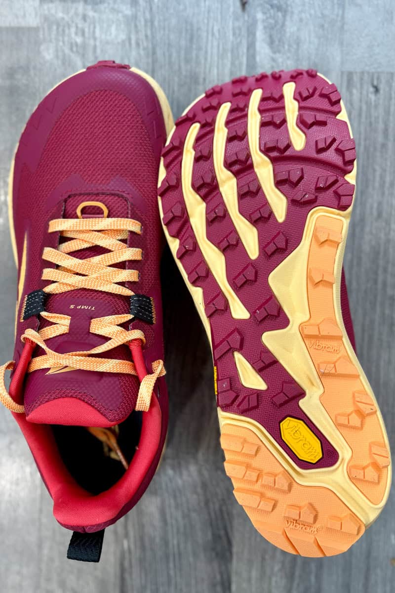 Pair of pink Altra Timp shoes with one shoe turned to show sole.