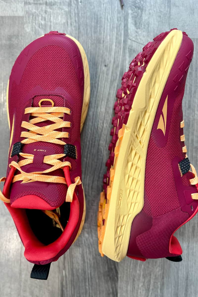 Pair of pink Altra Timp shoes with one shoe turned to show side profile view.