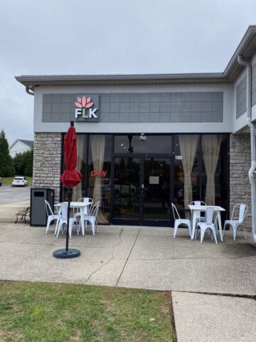 Floating Lotus Kitchen exterior with outdoor tables and chairs.