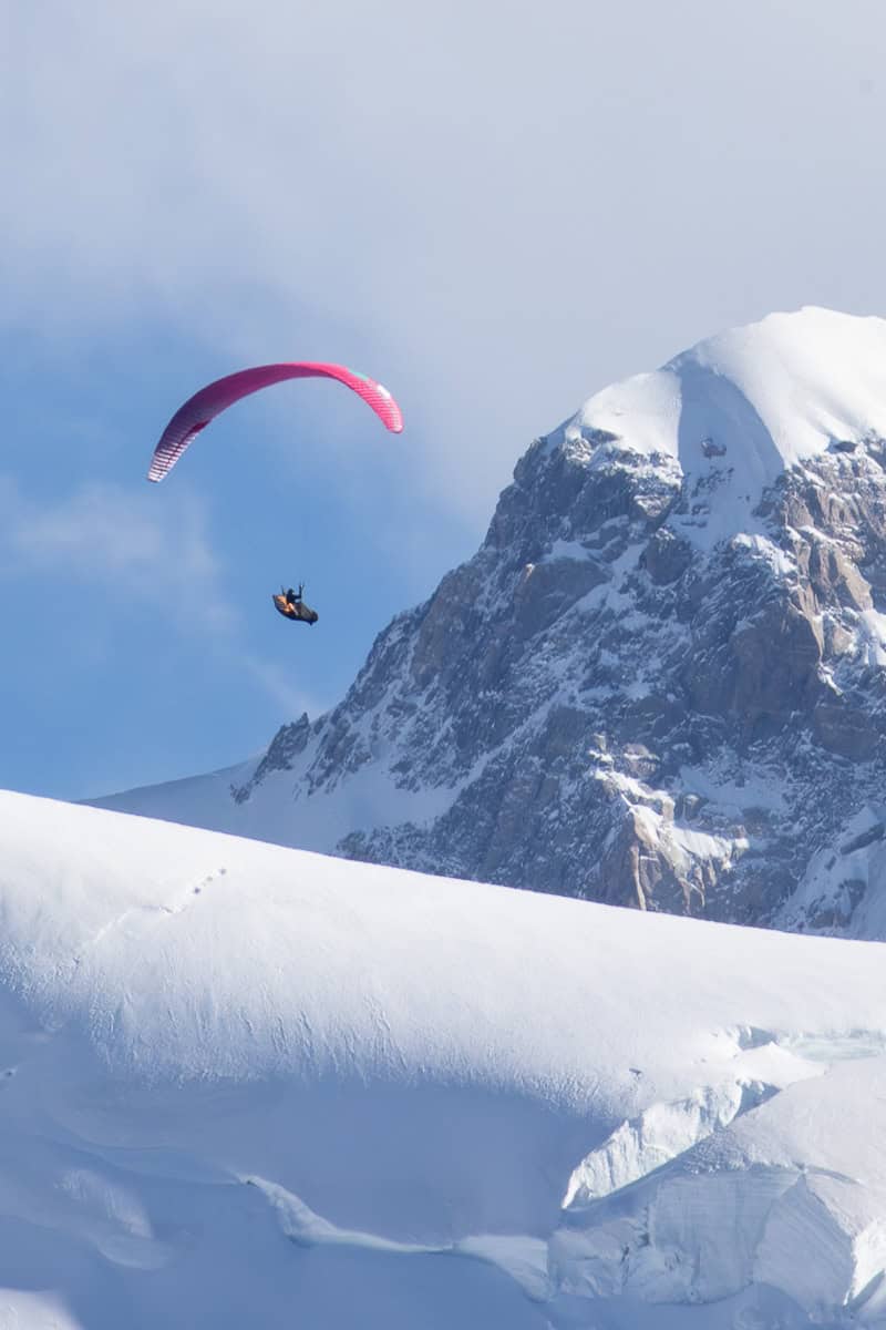 Parasailer aloft over snow-covered Mont Blanc.