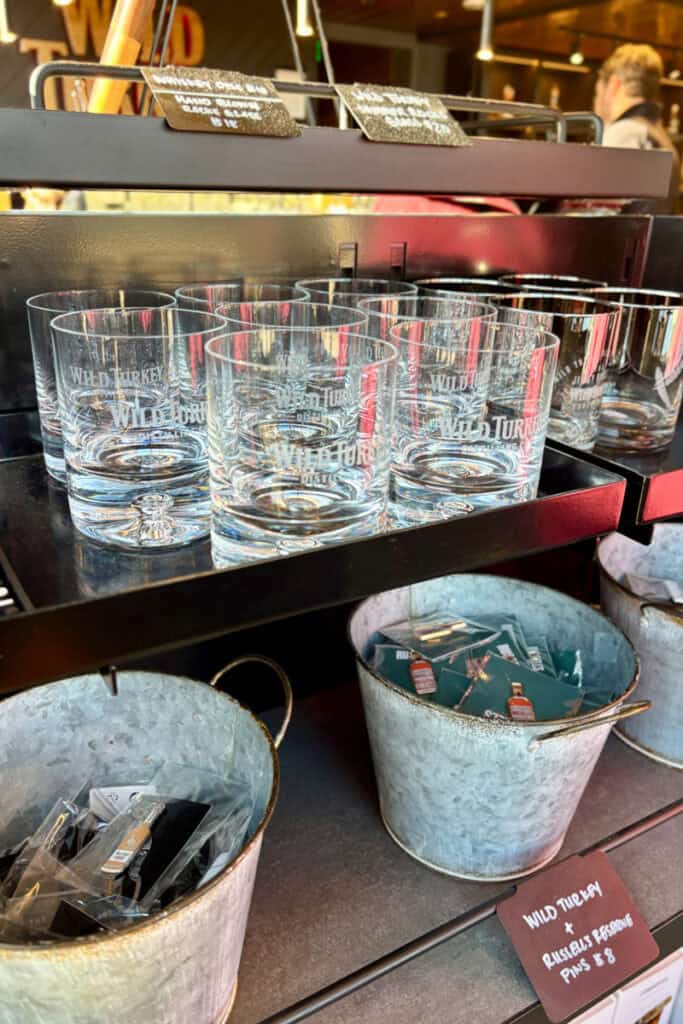 Wild Turkey bourbon glasses and souvenir pins for sale.