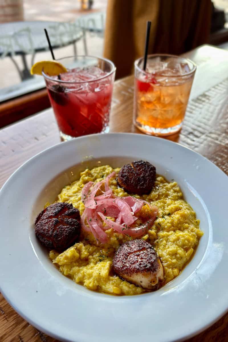 Seared scallops on grits.