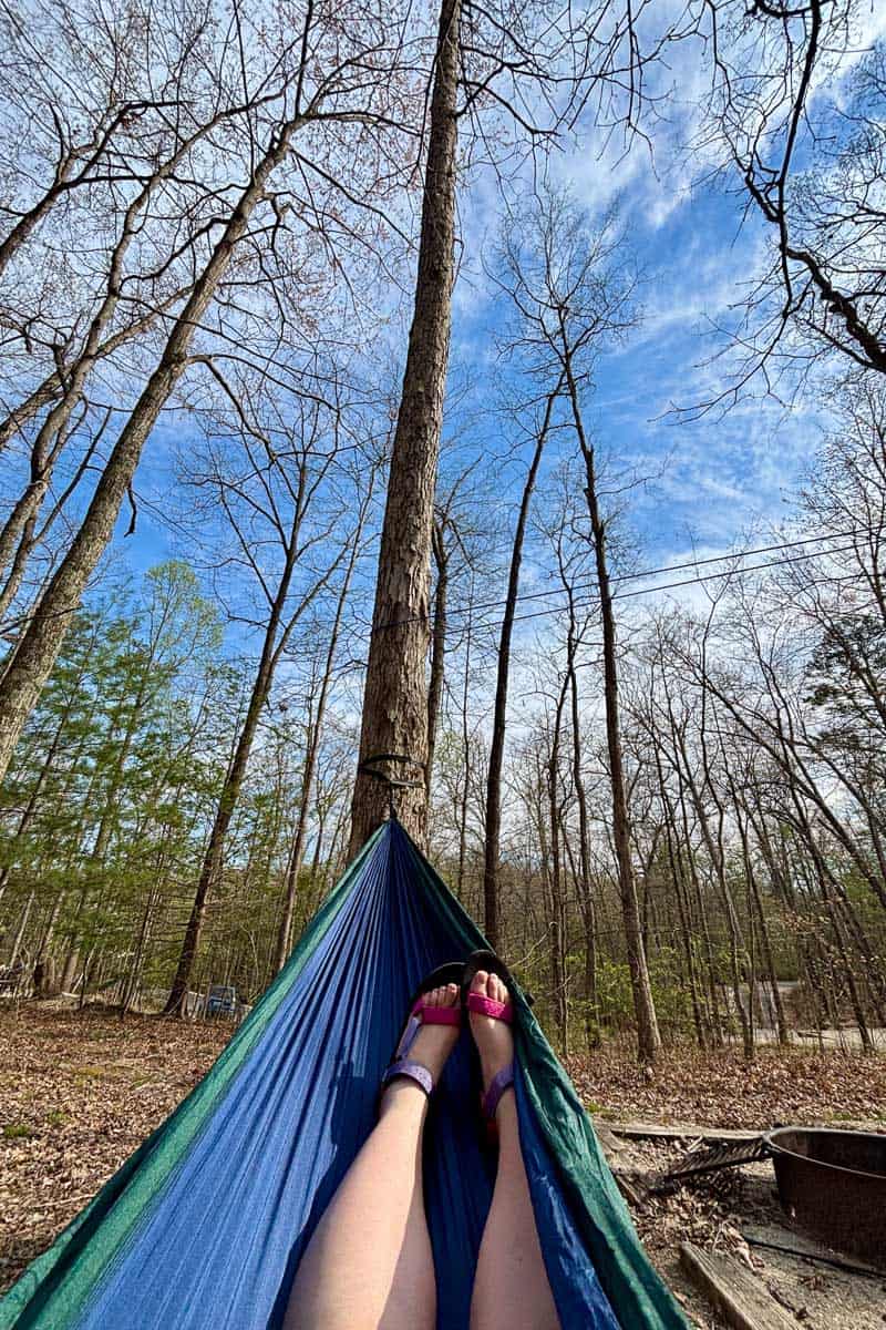 Camper relaxing in a hammock.