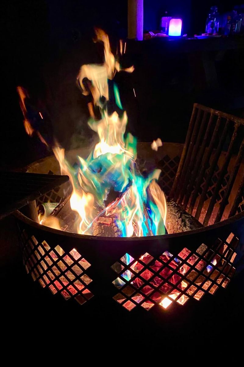 Campfire glowing with blue and green colors.