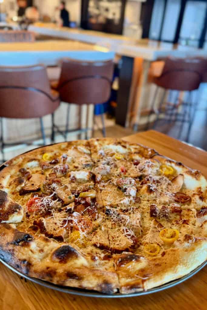 Hot Brown Pizza topped with turkey and bacon.