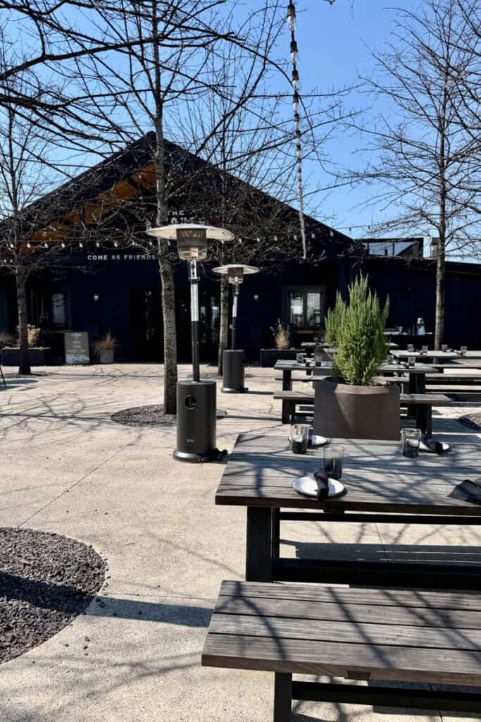 Picnic benches with table settings outside The Kitchen Table restaurant.