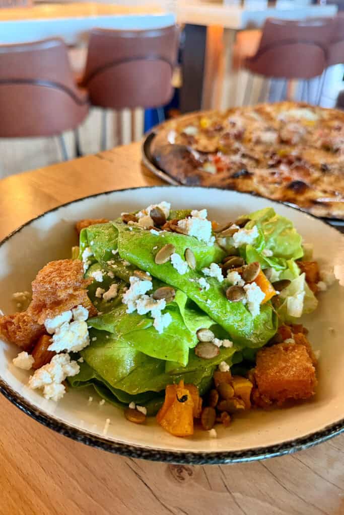 Bibb Salad with lettuce, roasted butternut squash, goat cheese, pumpkin seeds, and cinnamon croutons.