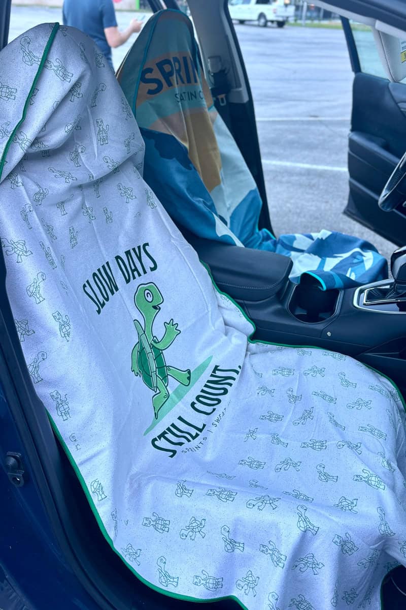 Car towels covering driver and passenger seats, possible gifts for trail runners.