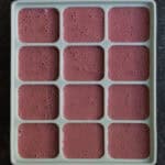 Chocolate cherry smoothie blend poured into silicone molds.