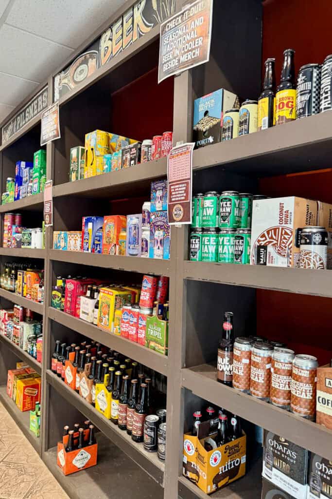 Shelves stocked with variety of beers for sale.