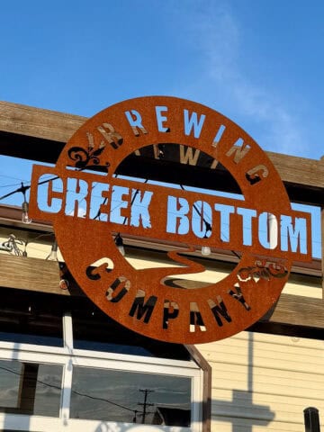 Metal sign with cut-out letters for Creek Bottom Brewing Company.