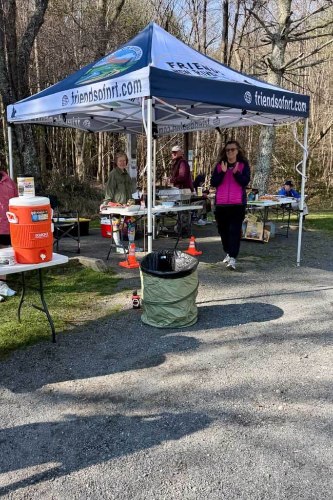Canopy shelter with food and water set up for runners of New River Trail races.