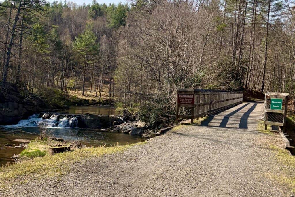 Bridge across Chestnut Creek with view of small waterfall.