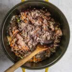Sausage and ground turkey added to cooked vegetables in Dutch oven.