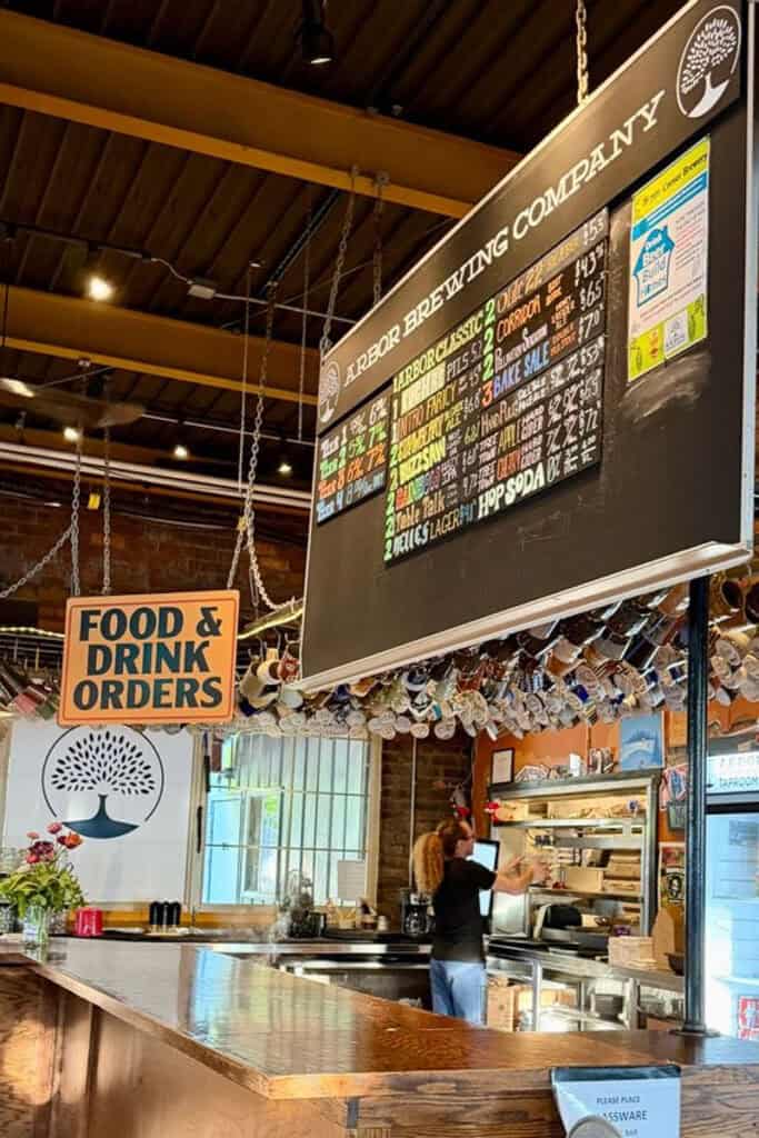 Bar area at Arbor Brewing Company with beers on tap listed.