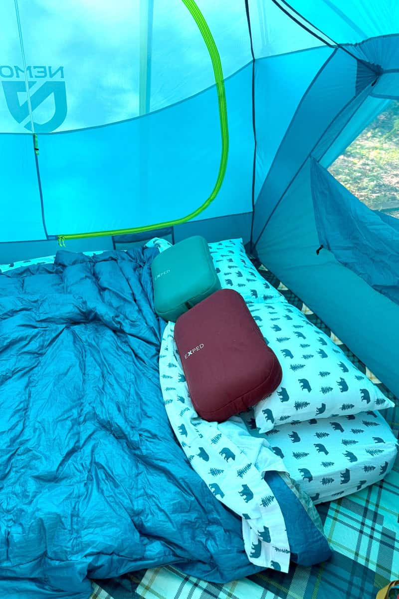 tent bedding with sheets and a down quilt.