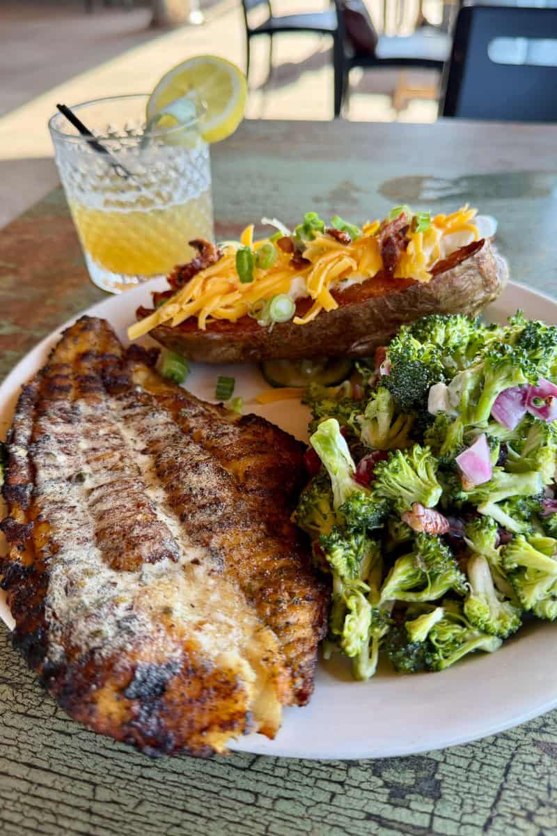 Blackened catfish with loaded baked potato and broccoli salad.