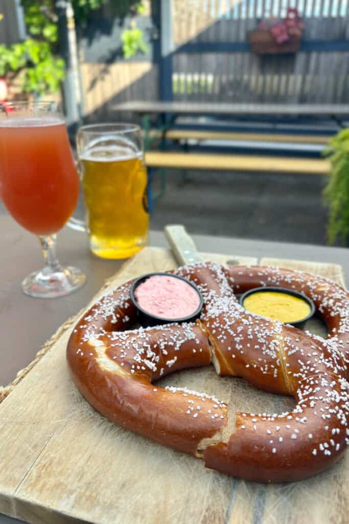 Large salted pretzel and dipping sauces.