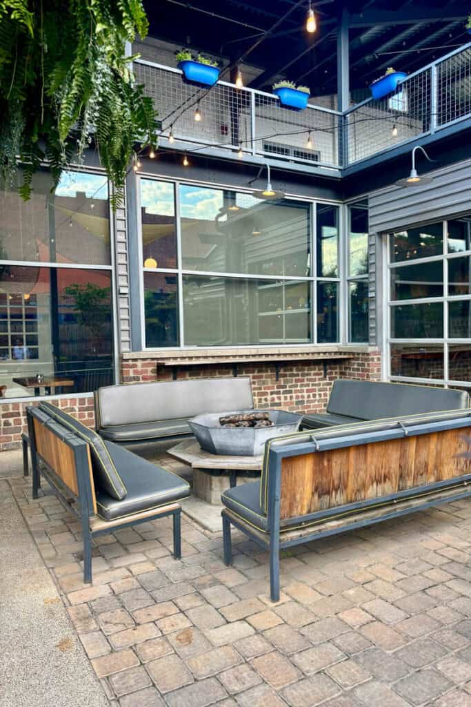 Benches around firepit in outdoor seating area at Bahnhof.