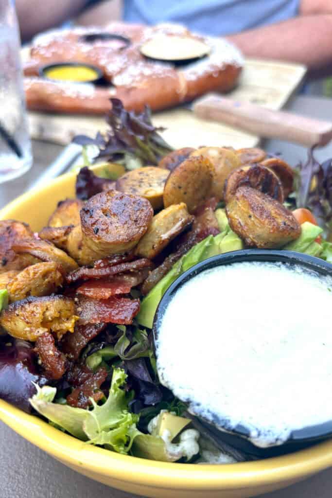 Avocado Meat Candy Salad with sausage, bacon, and tub of blue cheese dressing.
