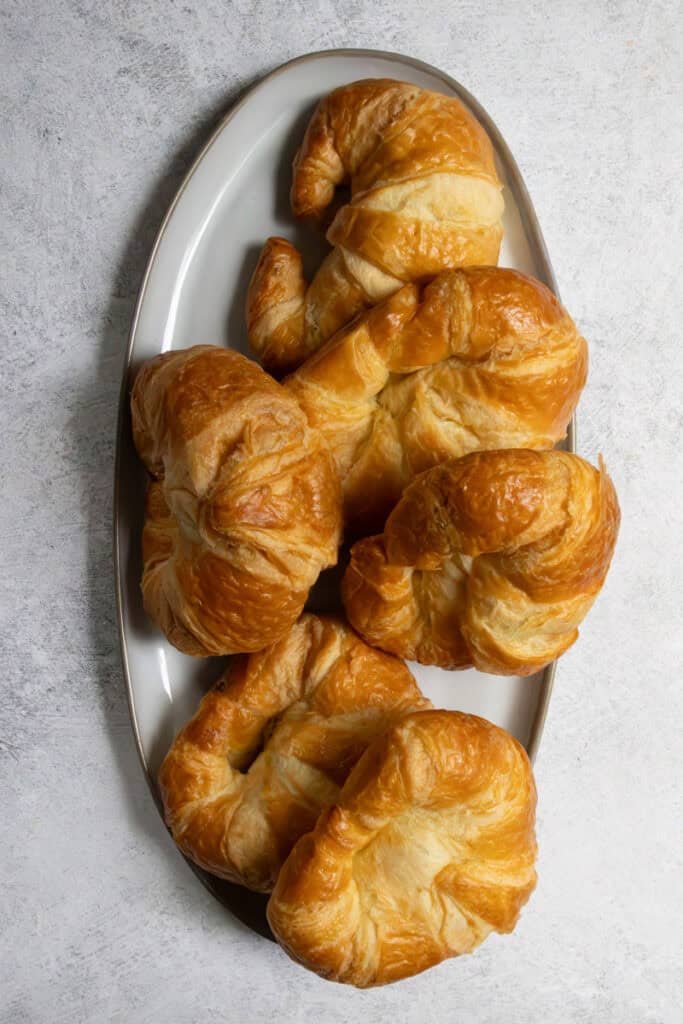 Plate piled with croissants.