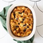 Baked croissant French toast with chocolate chips in a casserole dish.