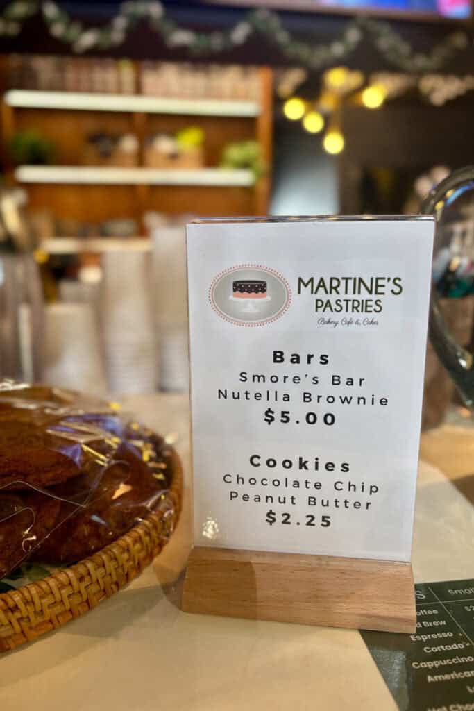Sign listing prices of bars, brownies, and cookies for sale.