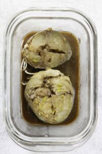 marinating mackerel steaks in a glass dish.