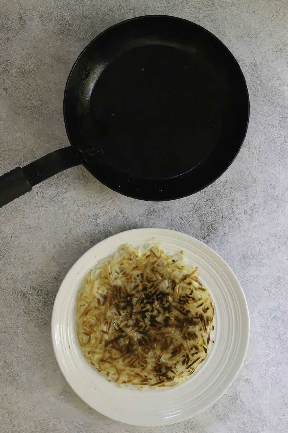 potato pancake flipped onto plate.