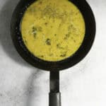 whipped eggs in omelette pan.