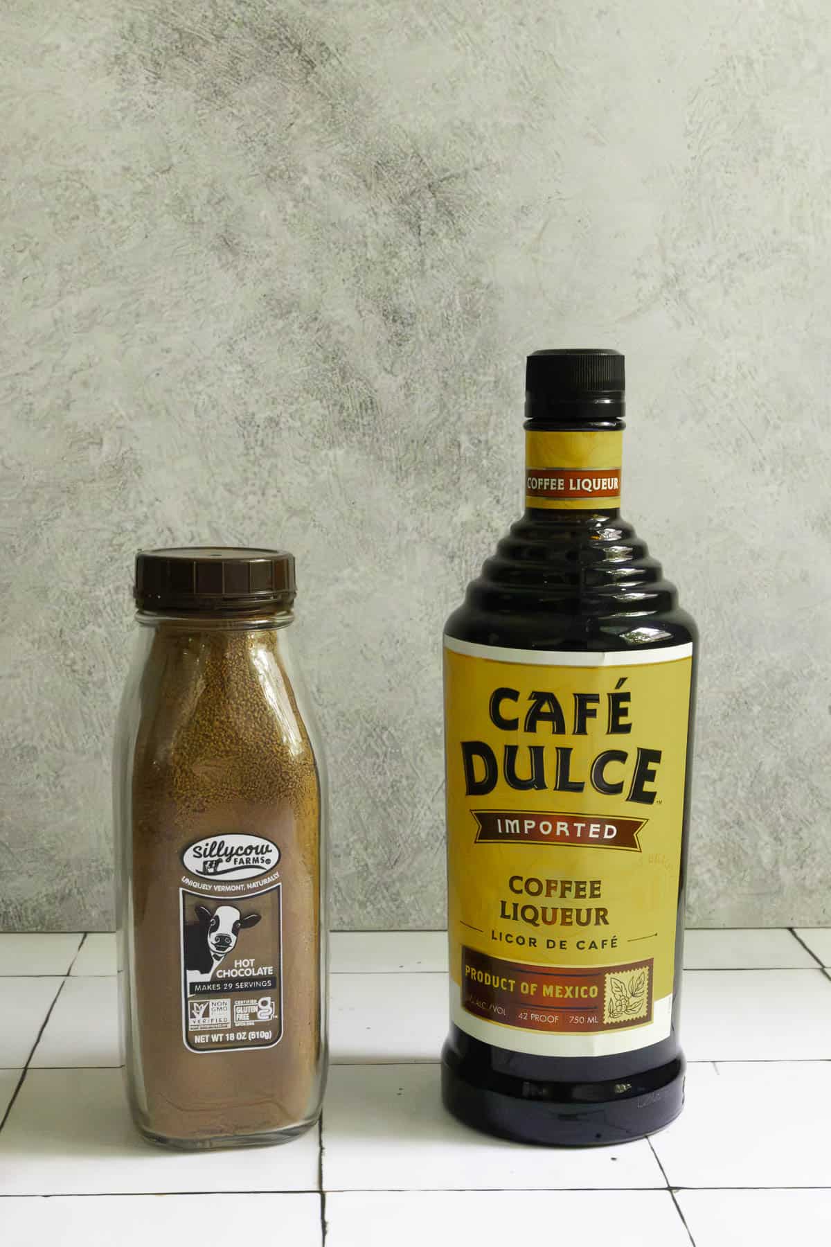 Bottle of coffee liqueur and jar of hot chocolate mix.