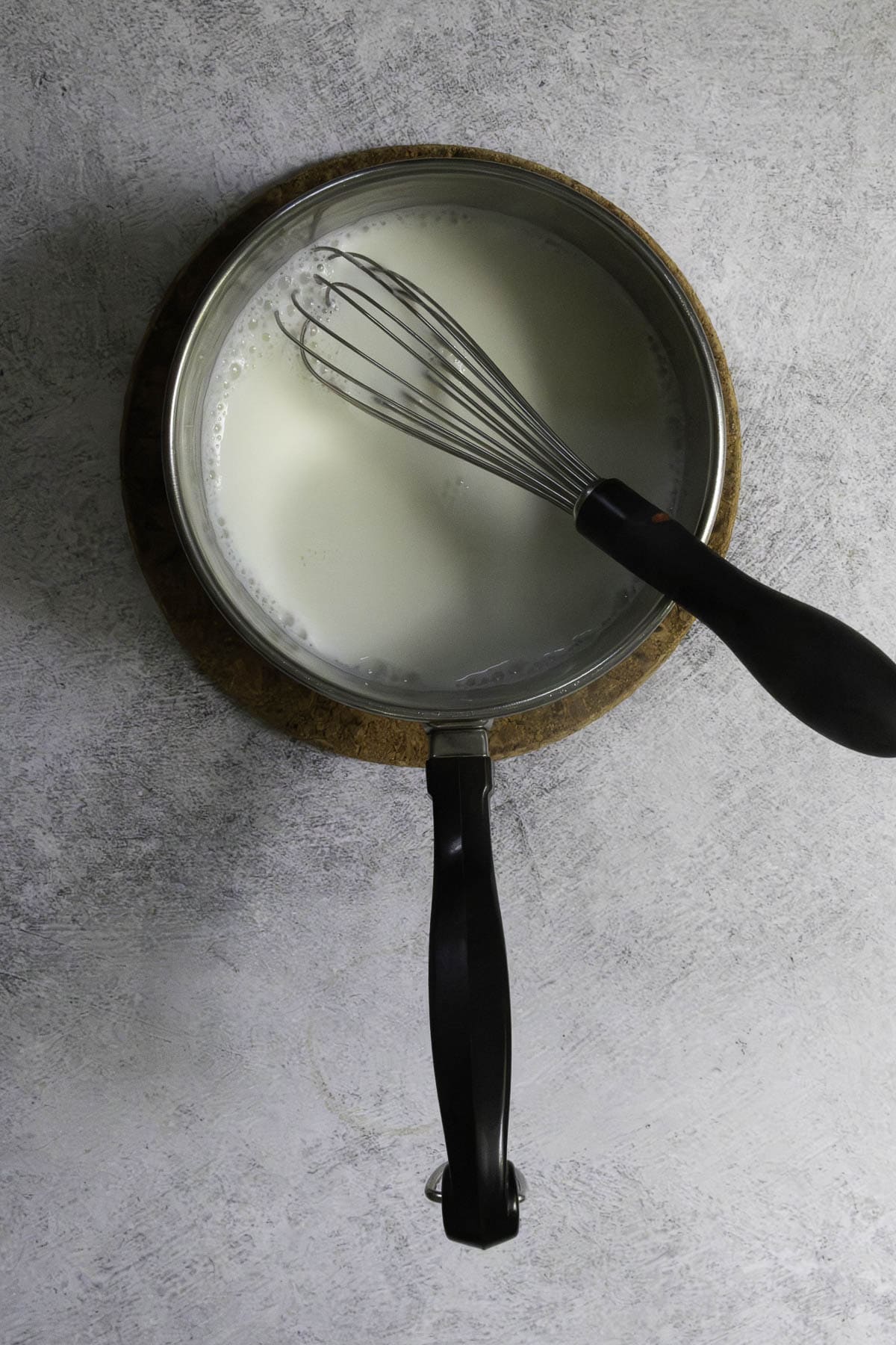 Milk and whisk in saucepan.