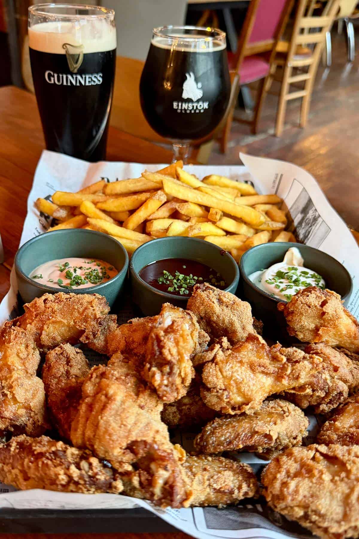 Fried food and dips with glasses of beer at Akureyri Backpackers Cafe.