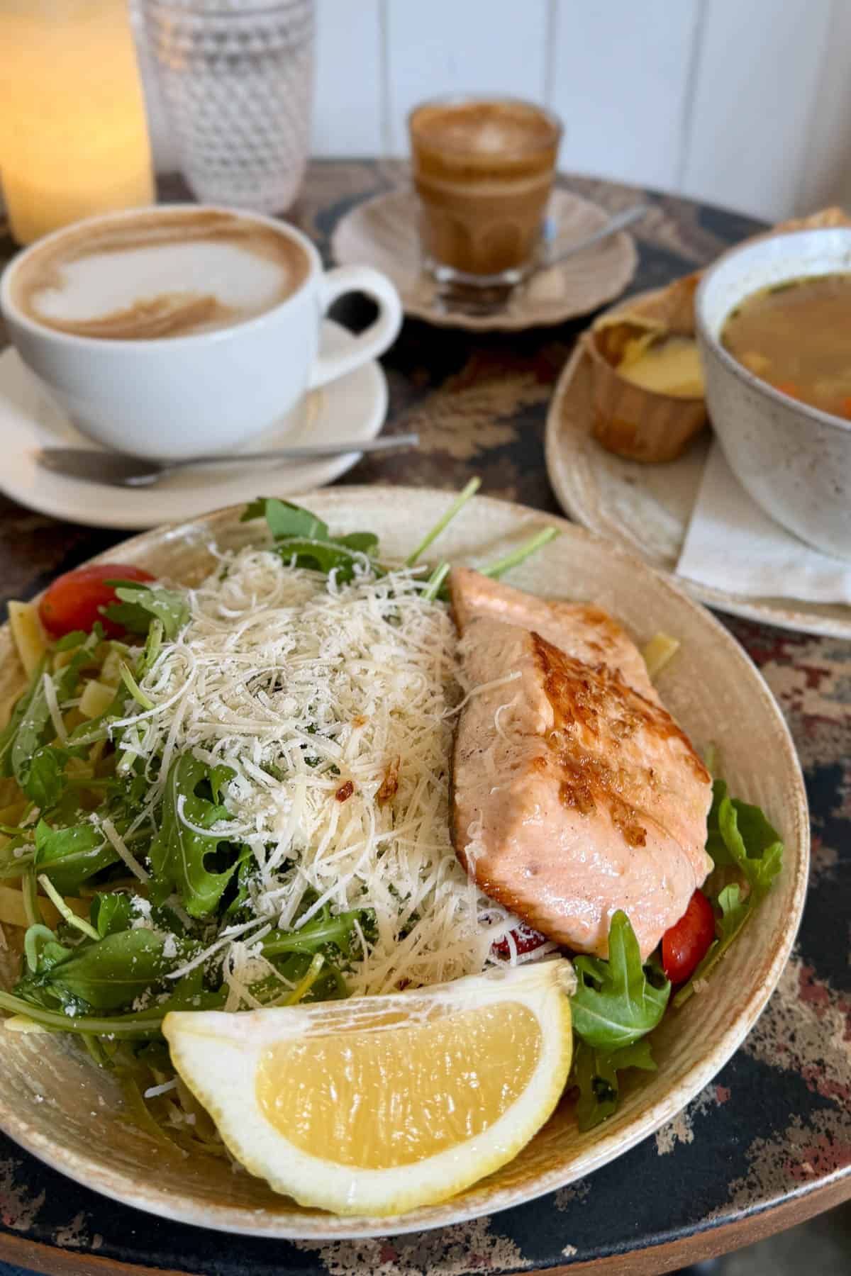 Pan-fried salmon served on a fettuccine, topped with an arugula salad.